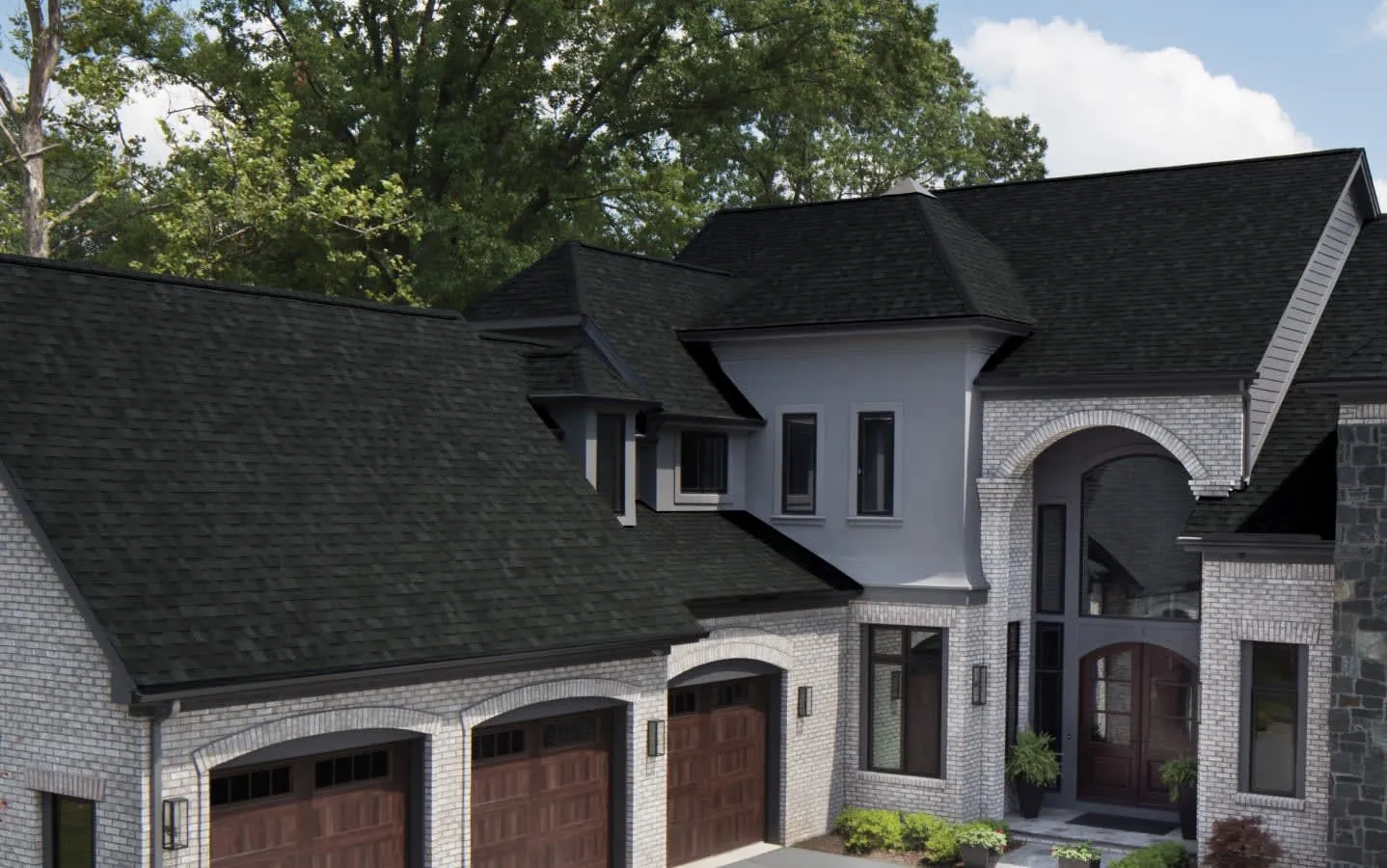 Architectural shingles in Onyx Black on a large two-story home (manufacturer photo)